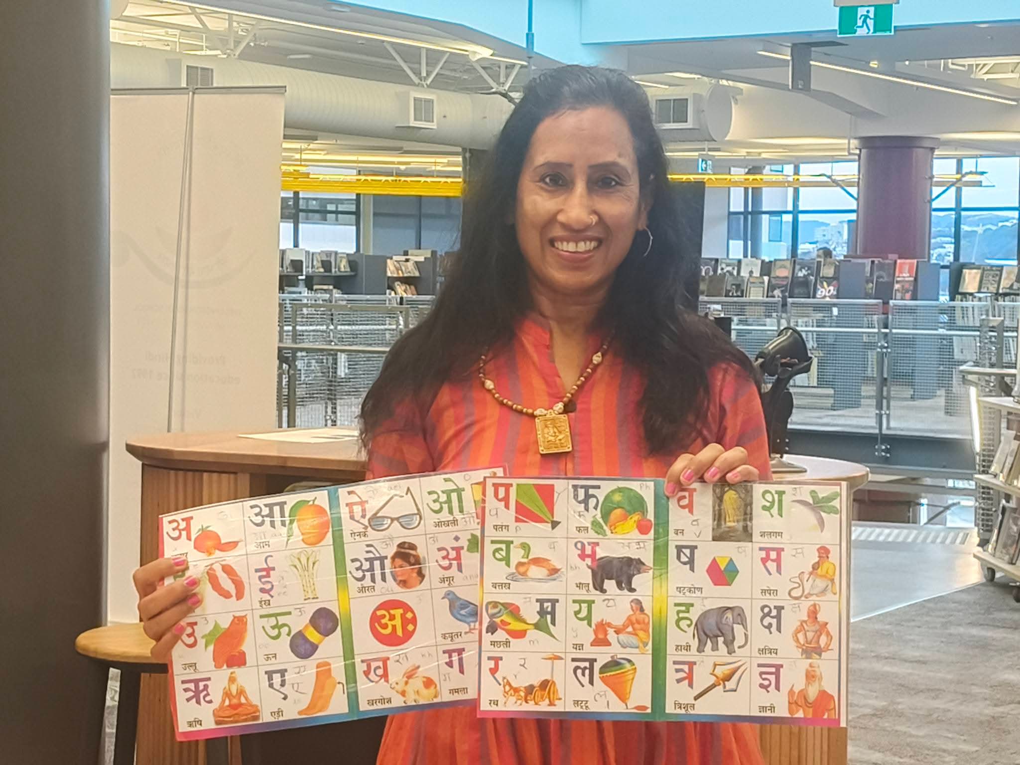 Anuradha Gupta holding Hindi learning books for private Hindi lessons